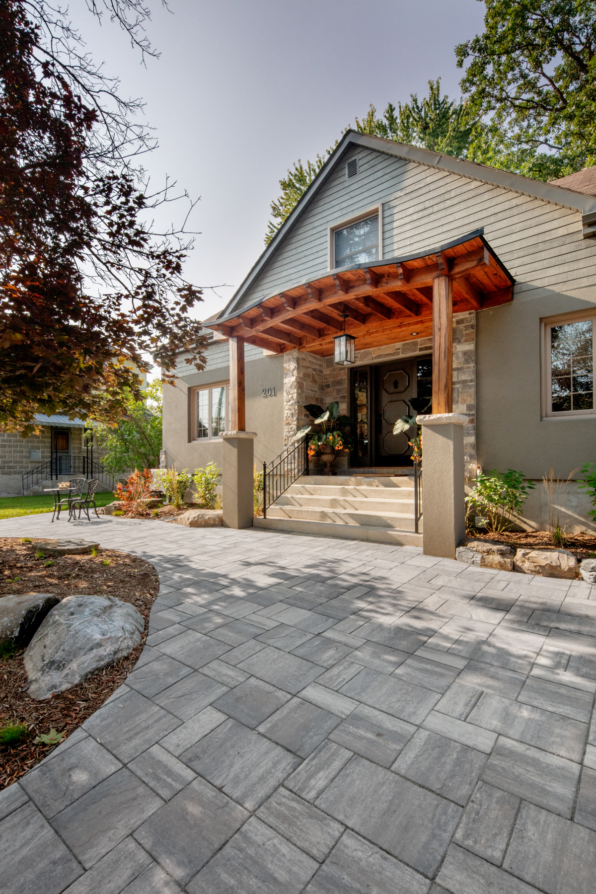 Transformed home exterior with new portico and stucco